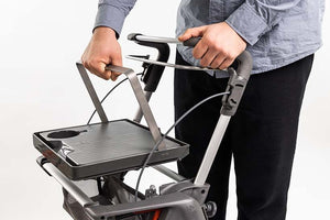 man removing the ToPro Hestia Rollator walker tray