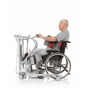 Patient seating on wheelchair ready to use Direct Healthcare Group MiniLift200 Mobile Sit-To-Stand Lift