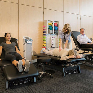 Stabil Pro 2-Section Treatment Table- Black in use by multiple people