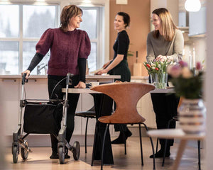 Woman using ToPro Troja Original Rollator with basket