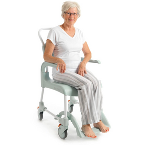 Etac | Enhance Comfort and Accessibility with the Clean Shower Commode Chair Designed for Easy Maneuverability and Optimal Hygiene woman using