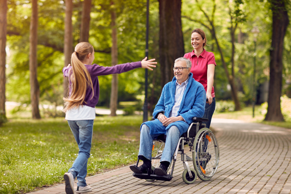 A girl running to her grandfather who's on a wheelchair