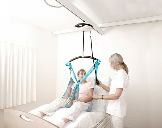 luna ceiling hoist in use by a female patient