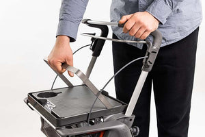 Man removing the ToPro Hestia Rollator food and drink tray