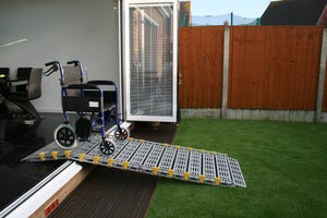 Roll-a-ramp portable and foldable disabled wheelchair ramp over door threshold