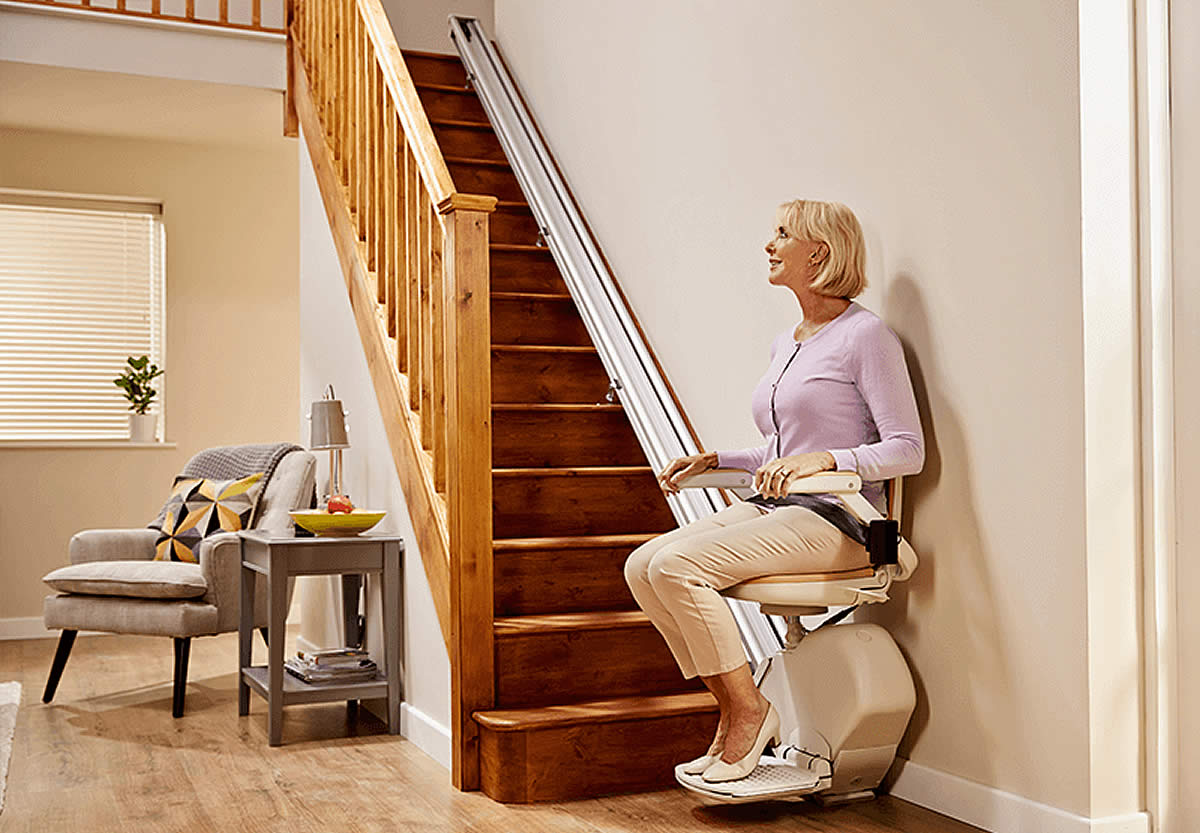 Acorn Stairlift 130 Straight Stairlift in use positioned at the bottom of stairs side view