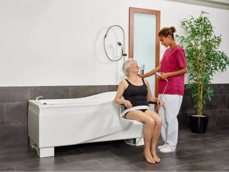 Astor Bannerman Compact DC3 Height Adjustable Bath with seat lift hoist in use