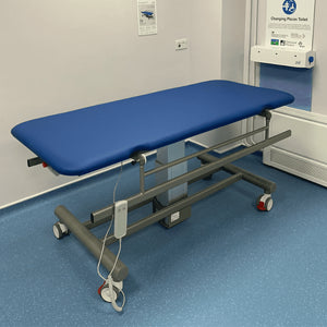 Astor Bannerman Electric Mobile Changing Table with adjustable height in a clinic or hospital