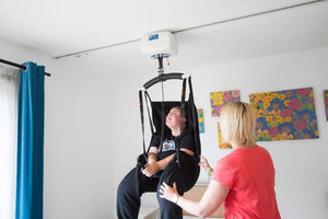 Astor Bannerman OT200 Ceiling Track Hoist in use to lift a patient