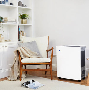 Blueair Classic 680i Air Purifier beside a chair