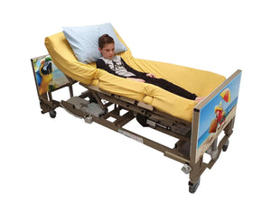 Centrobed Carribean Paediatric Turning Profiling Bed in use by a boy