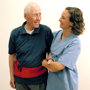 Direct Healthcare Group FlexiBelt Sit-to-Stand and Walking Support Belt worn by elder with the caregiver assisting them in a standing position