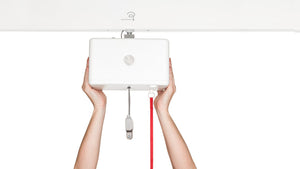 Direct Healthcare Group RiseAtlas 625 ceiling hoist box held by two hands