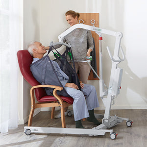 Hillrom M220 M230 Mobile Hoist in use to lift patient on a chair