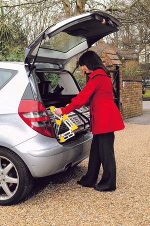 Loading the Roll-a-ramp portable and foldable disabled wheelchair ramp into car boot