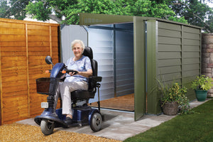 Woman on scooter outside the Trimetals Mobility Scooter Storage Shed. Secure Scooter Garage Protection Against Theft and Weather