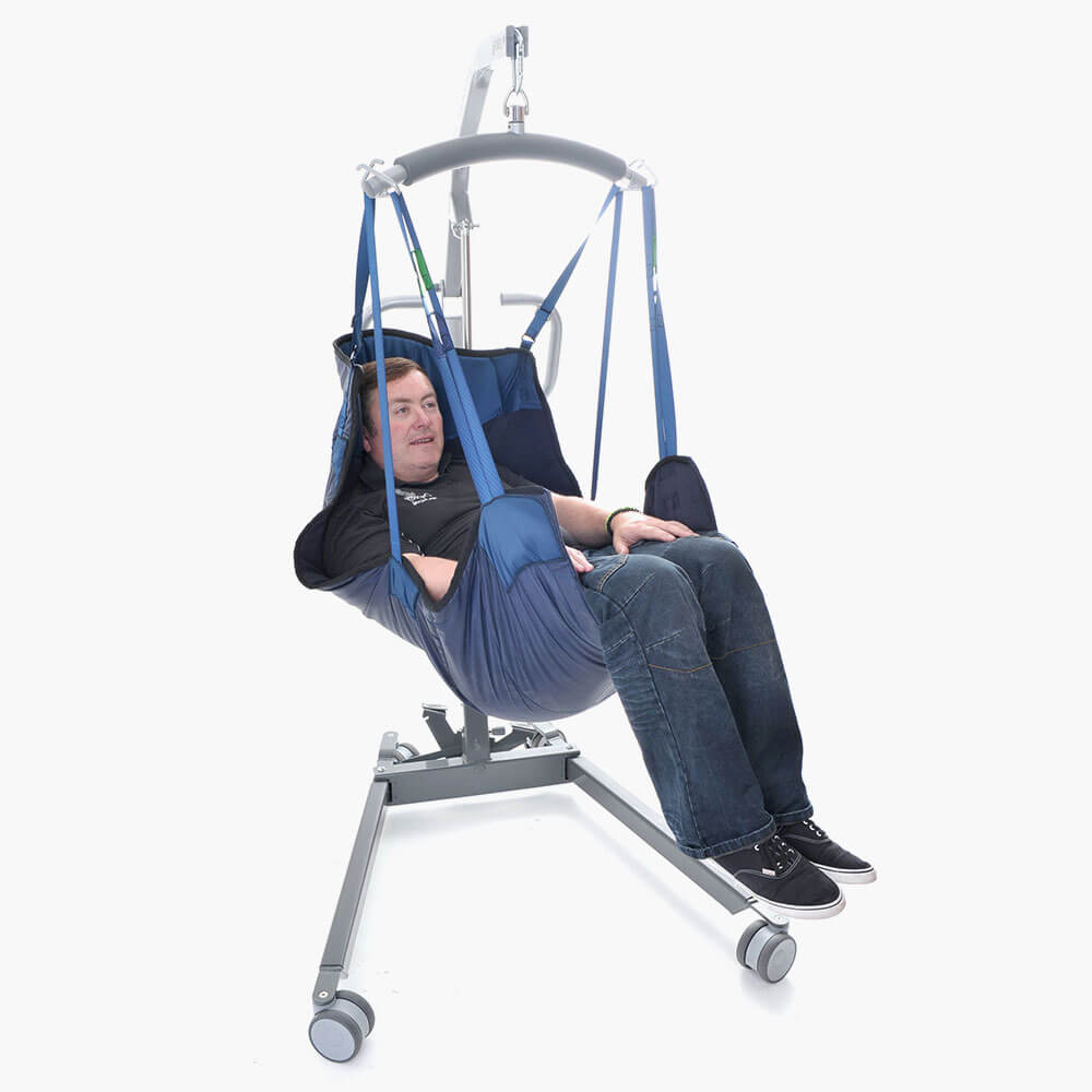 male patient in the Osprey Floor to Seat sling System hoisted with hoist