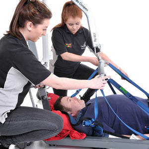 Two woman hoisting a male patient with the Osprey Floor to Seat System Support