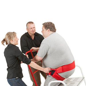 Side View of Patient Standing Up Using Direct Healthcare Group ReTurn7600 Sit-to-Stand and Transfer Assistive Device with the help of other people and a belt accessory