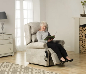 Woman sitting at Repose Olympia Rise and Recline Armchair with Duel Motor or Tilt in Space