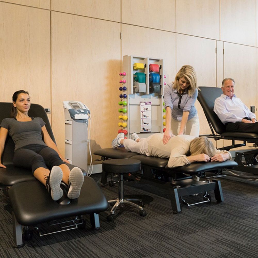 Stabil Pro 2-Section Treatment Table- Black in use by multiple people