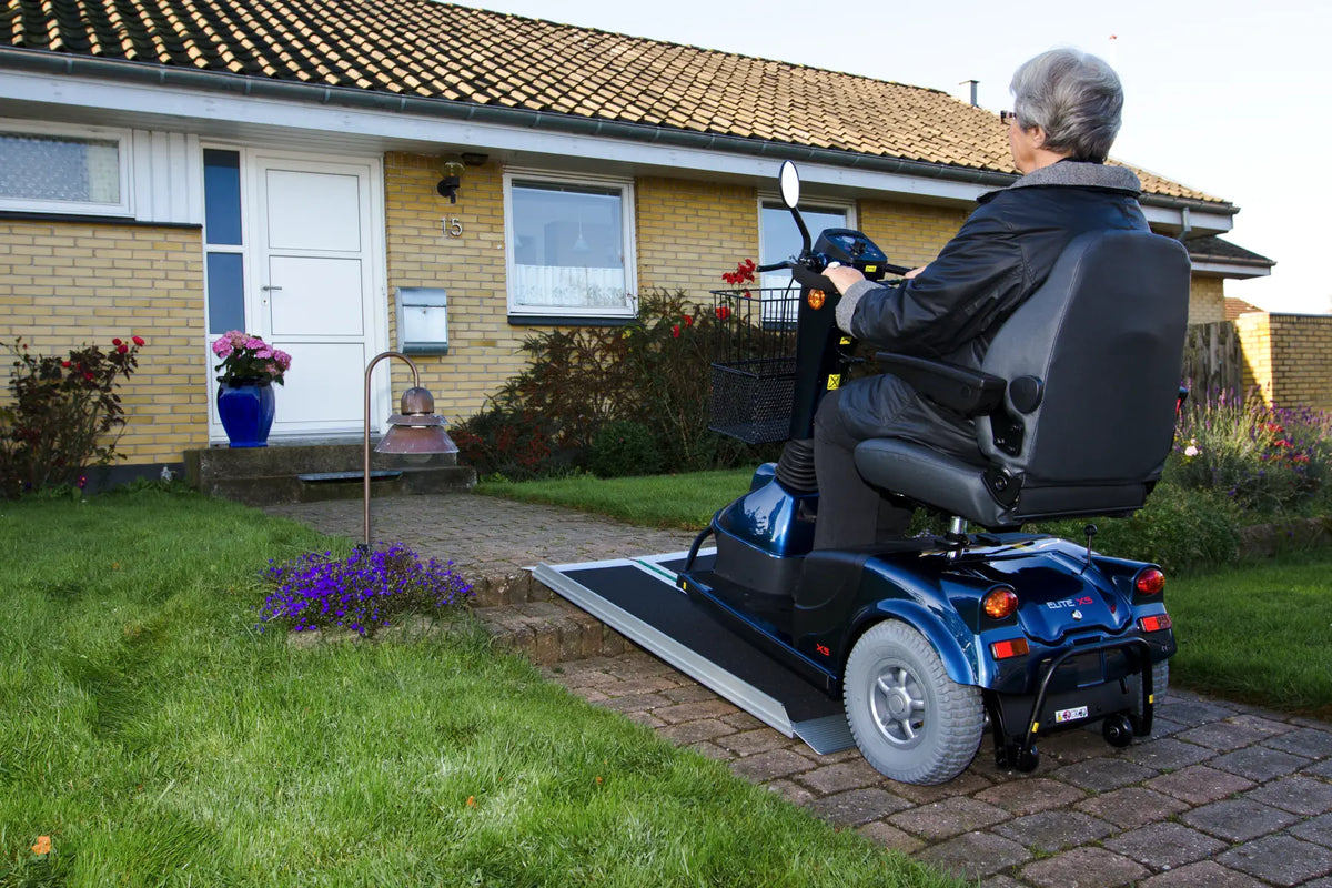Stepless Guldman EasyFold Pro Ramps being with a mobility scooter over it