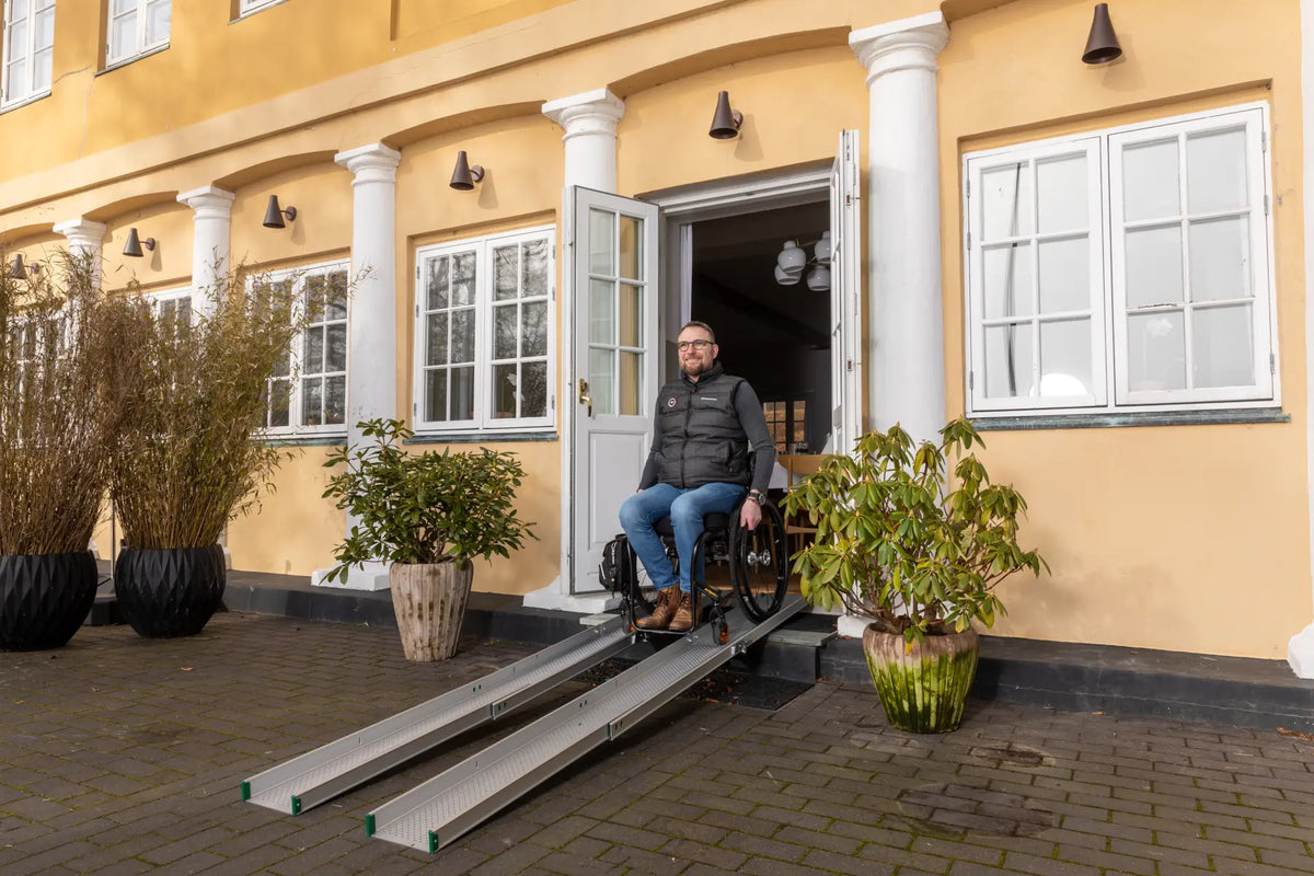 Stepless Guldman Folding Telescopic Ramp in use by a wheelchair user