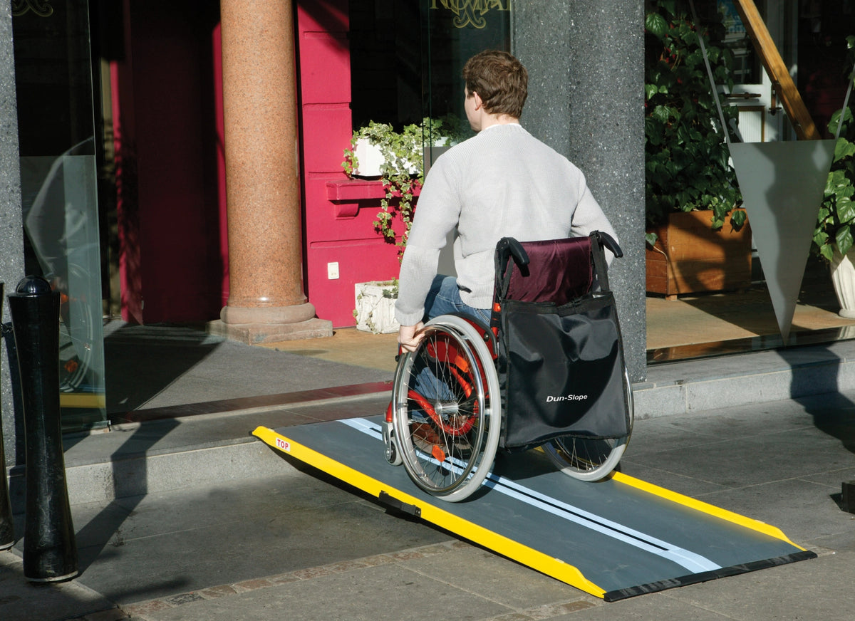 Stepless Guldman Lite Ramp in use by a man going in a building