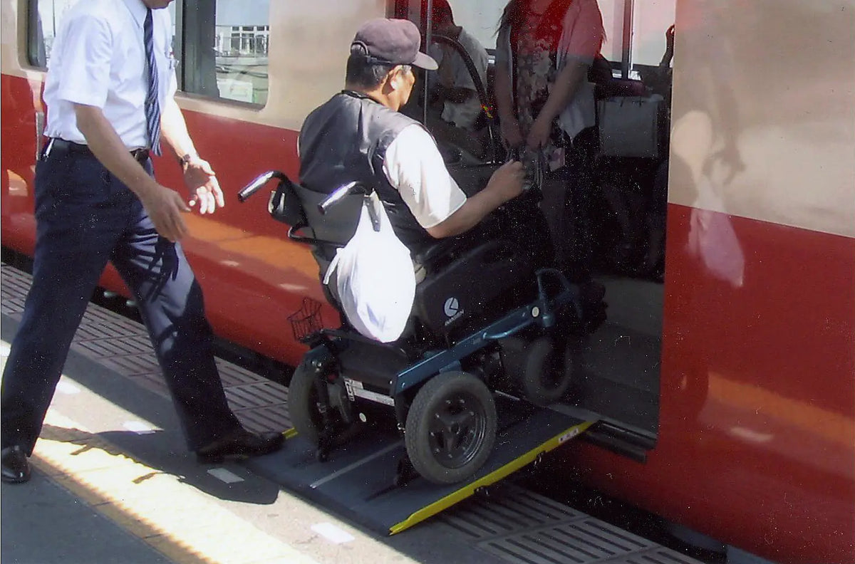 Stepless Guldman Lite Ramp in use by a man going in the train