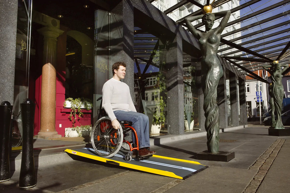 Stepless Guldman Lite Ramp in use by a wheelchair user