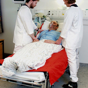 Direct Healthcare Group TurnSheet laid underneath a patient on hospital bed