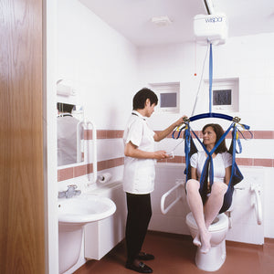 Chiltern Invadex Wispa 100 Series | Hoist Lift | Disabled Patient Ceiling and gantry Hoist    being used in toilet with patient