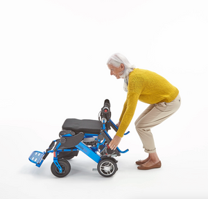 Motion Healthcare Foldalite Pro Folding Electric Wheelchair Blue woman folding