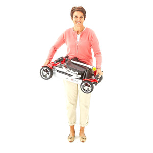 Motion Healthcare mLite, 4 Wheel, Lightweight, Folding Electric Mobility Scooter, grey Lithium Battery woman standing and holding