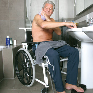 Direct Healthcare Group Combi Self Propelled Comode Shower Chair used by patient in bathroom 