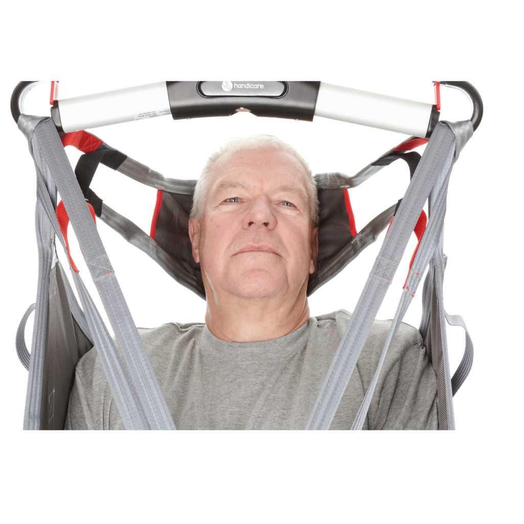 Direct Healthcare Group HeadSupport  attached to a sling bar supporting  patient&#39;s head on a hoist/sling