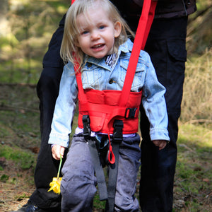 A kid being assisted wearing Direct Healthcare Group WalkingBelt Walking/Lift Aid  while walking