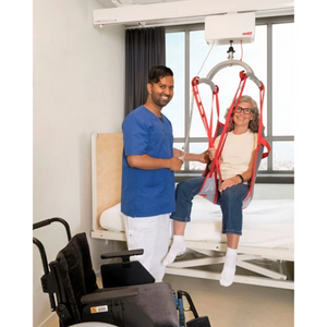 patient in a sling with a nurse using the Etac | Molift Air 200 Track Hoist For Ceiling Tracks and Gantry Systems