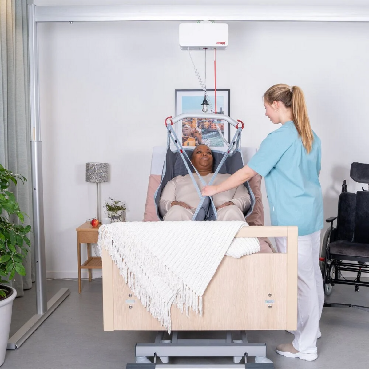 Etac | Molift Duo Lightweight, Free-Standing Overhead Hoist for Versatile Lifting Solutions A Free-standing Overhead Hoist System patient lifted on bed