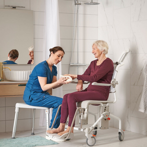 Etac | Swift Mobil-2 Shower Commode Chair Flexible, Accessible, and Comfortable Care Companion nurse helping the woman