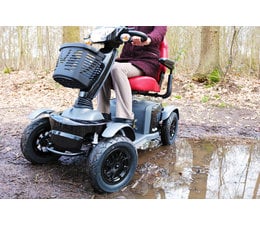 VanOs Excel Galaxy II Deluxe, 4 Wheel Mobility Scooter driving off road outdoors