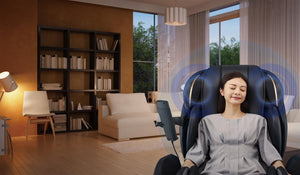 Black and grey Fujiiryoki JP-3000 Zero Gravity Massage Chair. Advanced 5D AI+ Full Body Massage Experience. Woman using bluetooth speakers