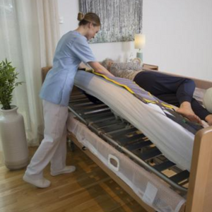 Invacare | Soft Tilt Automated and Manual Patient Repositioning for Enhanced Comfort and Care nurse using with woman in bed