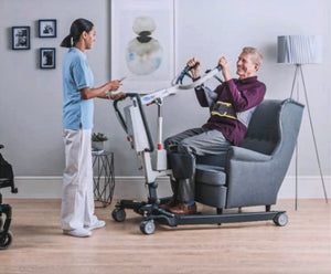 invacare stand assist isa patient lifter in use lifting patient from a chair