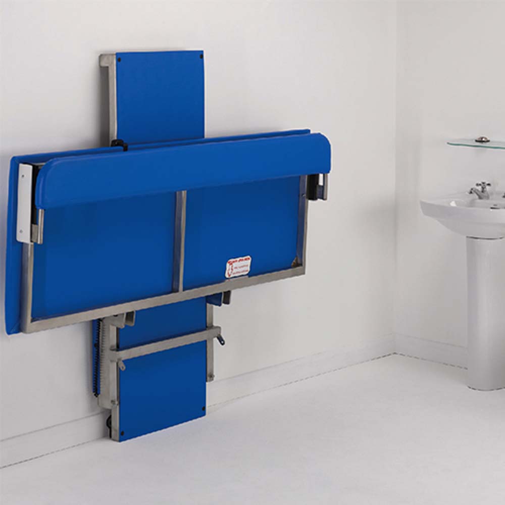 Prism Medical | Freeway Hi-Riser Electric Changing Table folded against wall