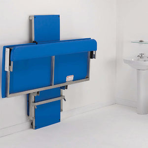 Prism Medical | Freeway Hi-Riser Electric Changing Table folded against wall