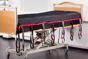 Direct Healthcare Group SafeHandlingSheet laid Horizontal Sling and Transfer Aid on top of hospital bed