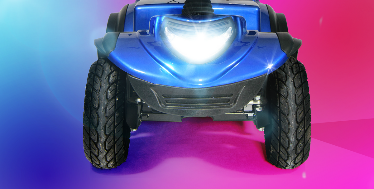 Blue Scooterpac Ignite Mini 8 MPH Electric Mobility Scooter. 35 Mile Range. Heated Seat. Compact Personal Mobility Solution front view with light on