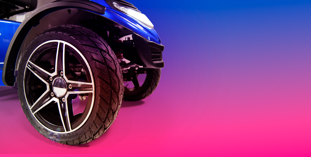 Blue Scooterpac Ignite Mini 8 MPH Electric Mobility Scooter. 35 Mile Range. Heated Seat. Compact Personal Mobility Solution front wheel close up