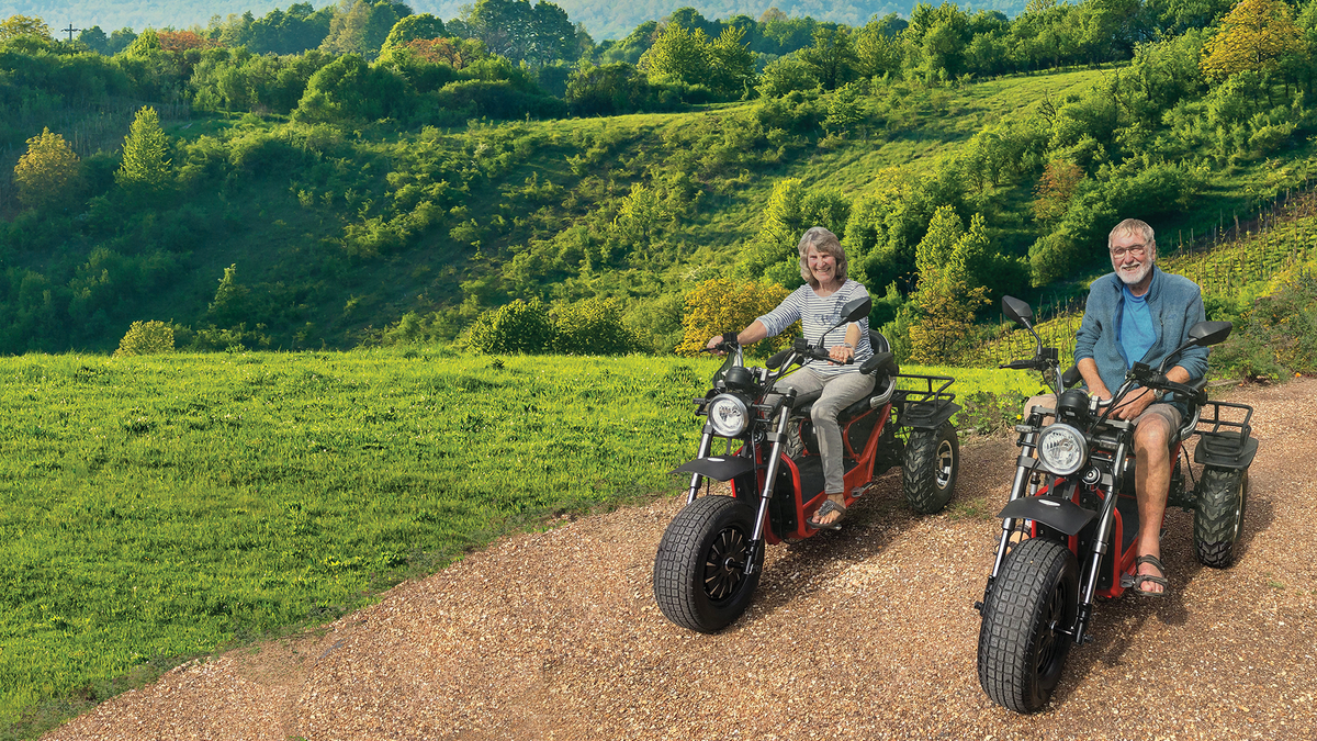 elderly couple riding red Scooterpac | Invader Off Road 16mph Electric Mobility Scooter 30 Mile range